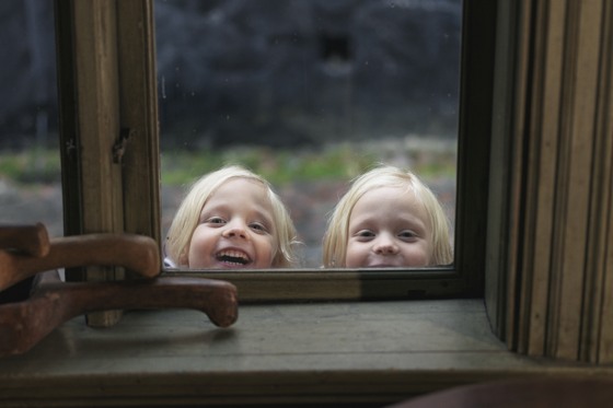 Girls curiously peek through the window