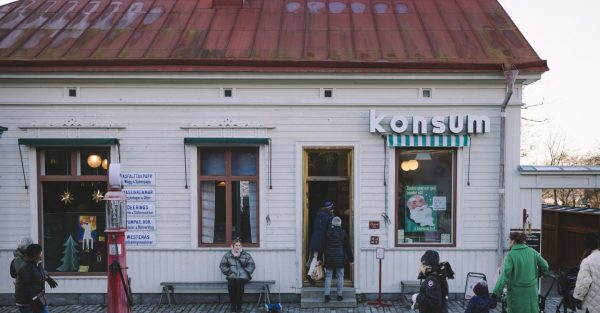 Guest by the historical Co-op Store at Skansen